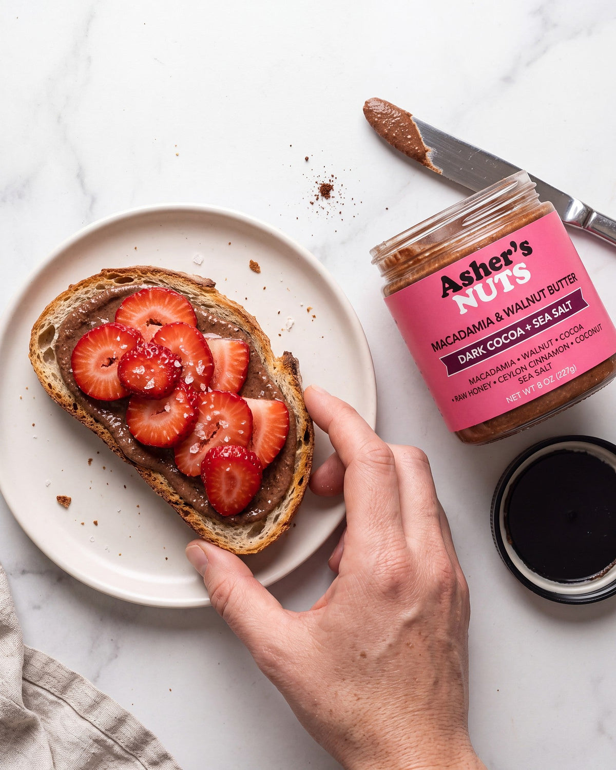 Sourdough toast with chocolate nut butter, sliced strawberries and flaky salt