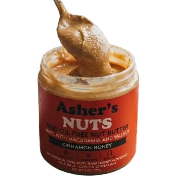 Jar of Asher's Nuts cinnamon honey nut butter with a spoonful on top