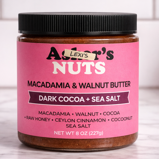 Jar of Lexi's Nuts Macadamia & Walnut Butter with pink label on a marble surface